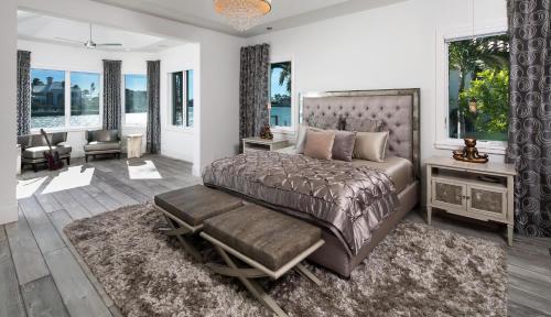a bedroom with a large bed and a large window at Meridian Blu in Marco Island