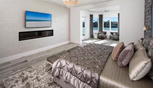 a bedroom with a large bed and a flat screen tv at Meridian Blu in Marco Island