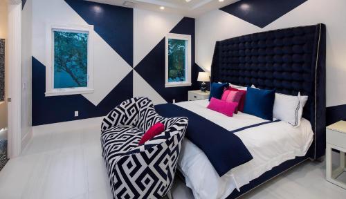 a bedroom with a large bed and a chair at Meridian Blu in Marco Island