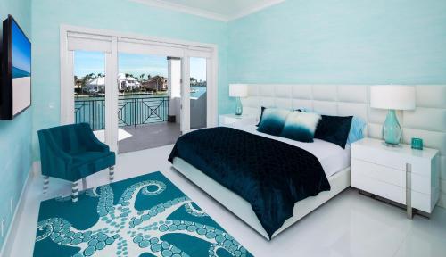 a blue bedroom with a bed and a balcony at Meridian Blu in Marco Island