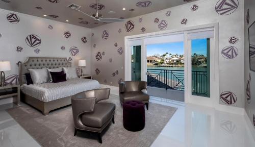 a bedroom with a bed and a balcony at Meridian Blu in Marco Island