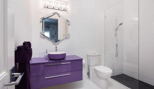 a bathroom with a purple sink and a shower at Meridian Blu in Marco Island