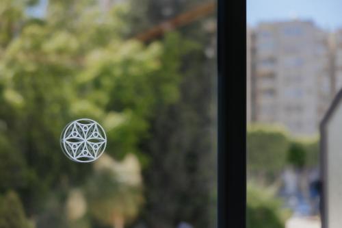 a window knob with a pentagonal symbol on it at Odysseia Hotel Kapetanios in Limassol