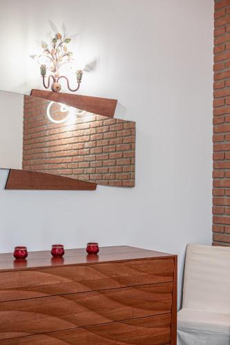 a living room with a brick fireplace and a dresser at Casa Gardenia -affittacamere in Gatteo
