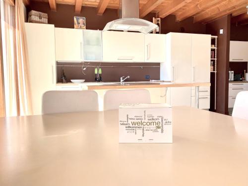 a box sitting on a table in a kitchen at Wohnung Mit Privatem Garten Und Schöner Aussicht in Moniga