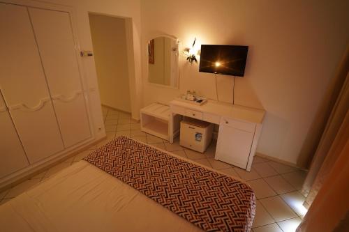 a small bathroom with a sink and a mirror at Hotel Nesrine Hammamet in Hammamet