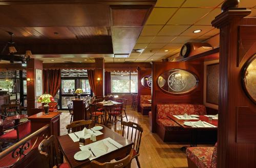 a restaurant with a dining room with tables and chairs at Odysseia Hotel Kapetanios in Limassol