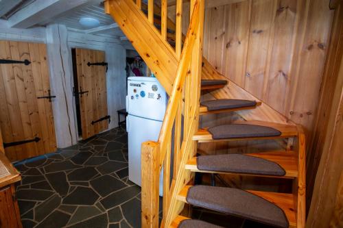 a staircase in a room with a refrigerator at Jõeveere majutus in Pärnu