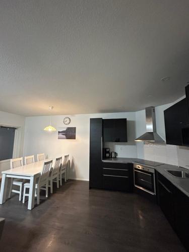 a kitchen and dining room with a table and chairs at Modern Slope apartment 2 in Vuokatti