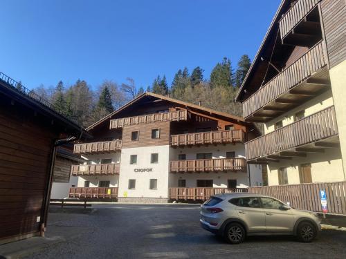 a small car parked in front of a building at Chopok Juh apartmán Yeti in Horná Lehota