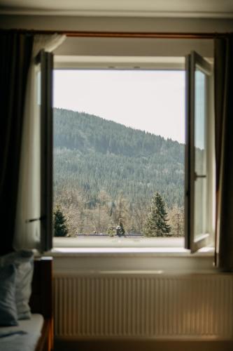 a window in a room with a view of a mountain at Hotel Kristian in Kubova Huť