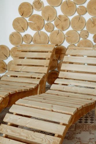 two wooden keyboards sitting next to a wall of logs at Hotel Kristian in Kubova Huť