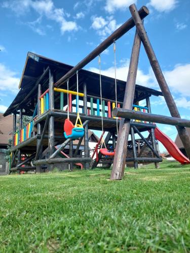 a playground with swings in front of a building at New Wolf in Bran