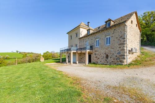 an old stone house on a grassy field at Gîte de Lucie - Climatisé avec jardin de 800 m² in Lunac