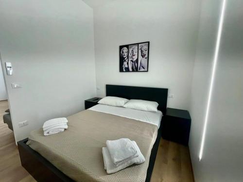 a bedroom with a bed with two towels on it at Arcobaleno B in Faenza