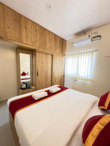 a bedroom with a large bed and a window at Sai Grand Villa Hotel Near Bangalore Airport in Bengaluru