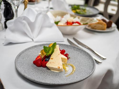 a plate of food on a table with strawberries at Smygehus Havsbad in Smygehamn