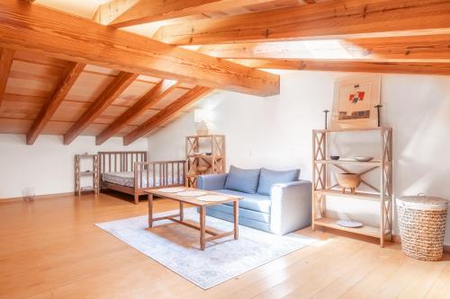 a living room with a blue couch and a table at Finca can Mandai in Son Carrió