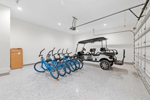 a group of bikes parked in a room with a golf cart at Somewhere With You in Inlet Beach