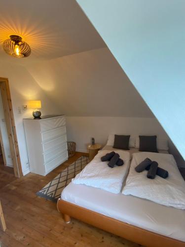 a bedroom with a bed with two pillows on it at gemütliche rustikale Wohnung mit Kamin und optionalem Whirlpool in Bad Sobernheim