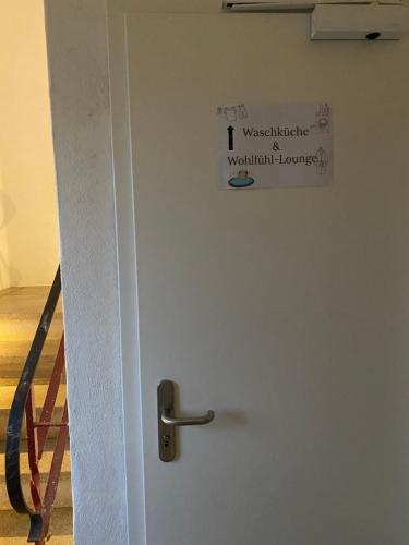 a door with a sign on it next to a staircase at gemütliche rustikale Wohnung mit Kamin und optionalem Whirlpool in Bad Sobernheim