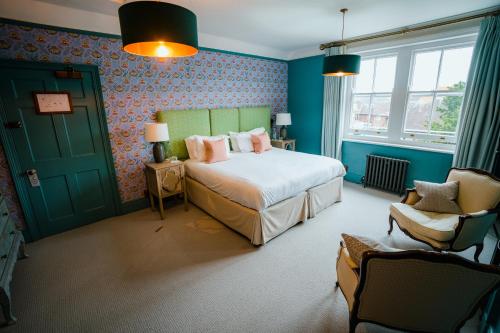 a bedroom with a bed and a green door at Purchases Restaurant & Accommodation in Chichester