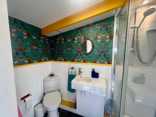 a small bathroom with a toilet and a sink at The Escape in Crackington Haven