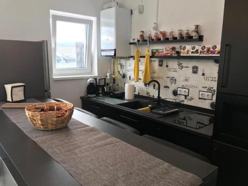 a kitchen with a sink and a basket on a counter at Fok Flat Sibiu in Turnişor