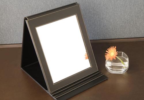 a picture frame with a flower in a glass vase at Hotel Mystays Premier Akasaka in Tokyo