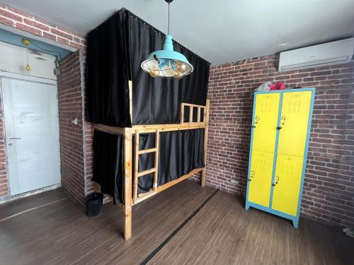 a room with a black curtain and a bed in a brick wall at Lola backpacker's Hostel in Istanbul