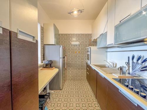 a kitchen with a refrigerator and a sink at Vera in Oggebbio