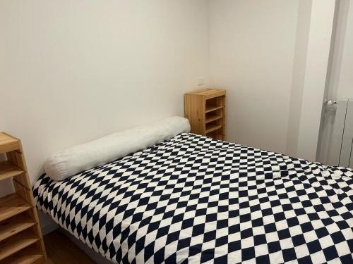 a bedroom with a black and white checkered bed at Vera in Oggebbio