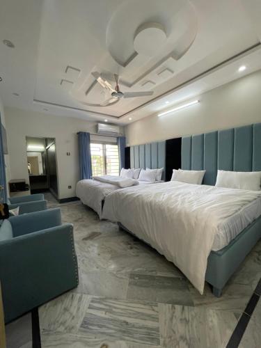 a large bedroom with two beds and a couch at Aban Suites in Dargai