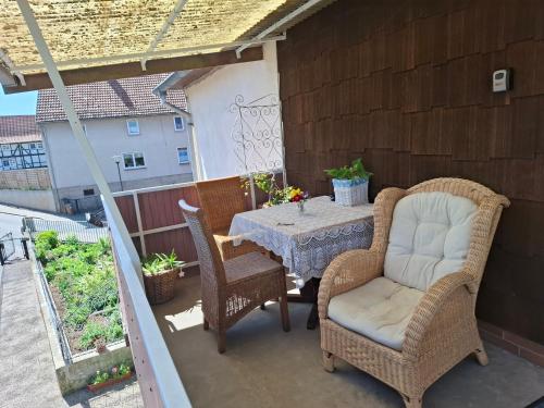 a patio with a table and chairs on a balcony at Ferienhaus Stani in Eschwege
