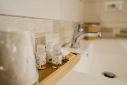 a bathroom sink with bottles of essential oils next to a sink at Le Terrazze Sul Lago in Posta Fibreno