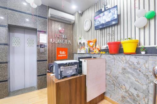 a waiting room with a tv and a cash register at Hotel G Inn I in Lucknow
