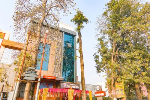 a building on the side of a street with trees at Hotel G Inn I in Lucknow