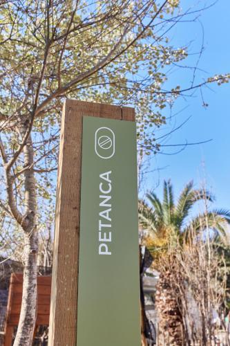 a sign for a building with trees in the background at TAIGA Delta de l'Ebre in L'Ampolla
