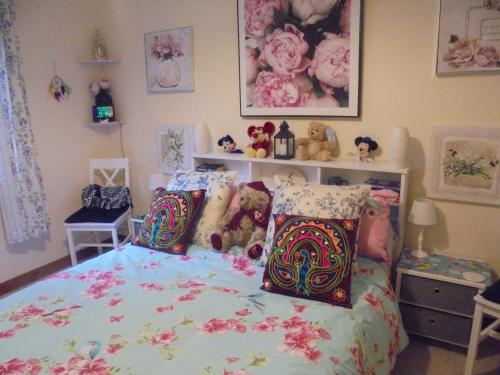 a bedroom with a bed with stuffed animals on it at 3 Station Court, Munlochy in Munlochy
