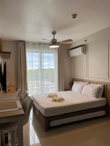 a bedroom with a large bed and a window at AR's Staycation in Lapu Lapu City