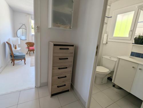 une salle de bain avec toilettes, lavabo et miroir dans l'établissement Esprit vacances entre jardin & plage du Porteau, à Pornic