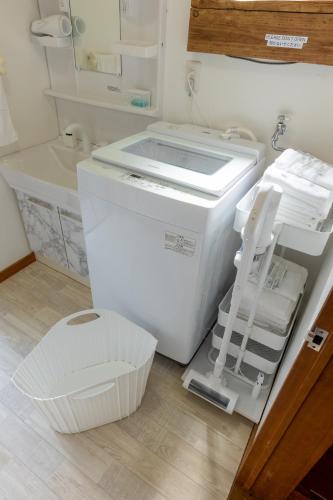 a kitchen with a sink and a toilet in a room at Lake England 富士山が見える隠れ家ロッジ in Fujikawaguchiko