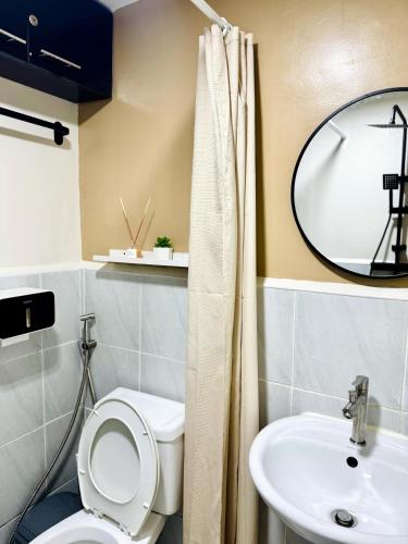 a bathroom with a toilet and a sink at AR's Staycation in Lapu Lapu City