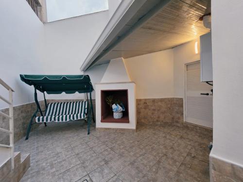 a living room with a bench and a fireplace at Astrum - Casa Vacanze a Mesagne in Mesagne
