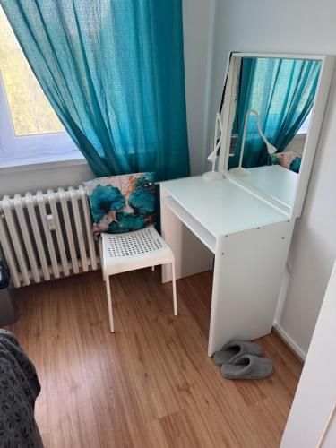 a dressing table with a mirror and a crib in a room at Krásný prostorný byt in Karviná