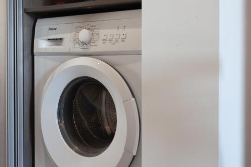a white washing machine with its door open at Appartement Lumineux refait à Neuf in Sanary-sur-Mer