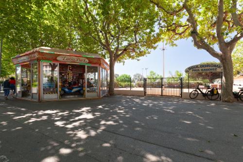 a park with a toy store next to a tree at Appartement Lumineux refait à Neuf in Sanary-sur-Mer