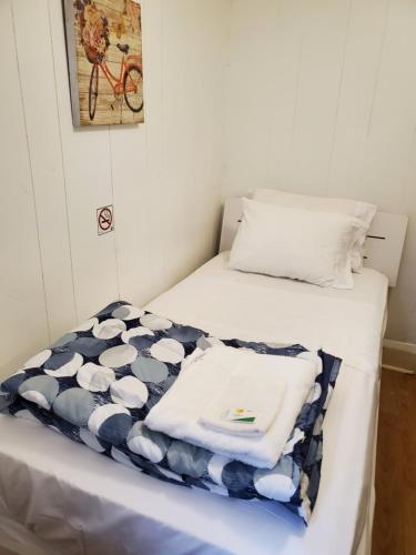 a room with two beds with towels on it at Toronto Little Italy Guest House in Toronto