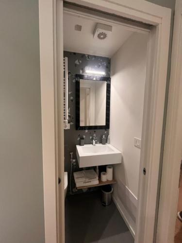 a bathroom with a sink and a mirror at A Casa Di Lu Na 3 in Bologna