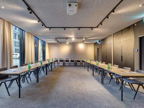 a large room with tables and chairs in it at Mercure Zürich City in Zürich